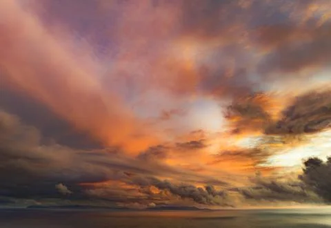 Dramatic sunset sky with vibrant orange and pink clouds over the ocean Stock Photos