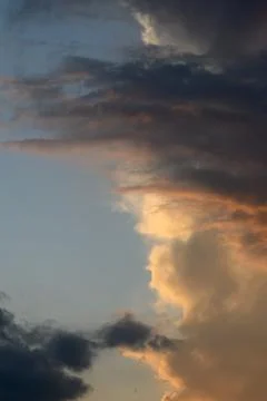 Dramatic sunset skyscape with contrasting dark clouds and golden illuminate.. Stock Photos