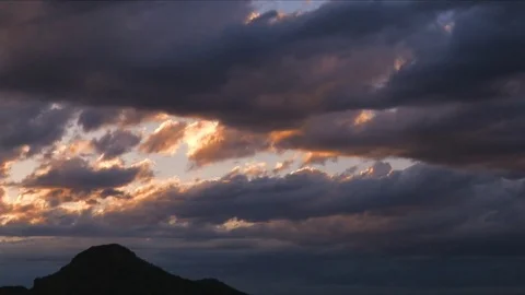 Dramatic sunset with storm clouds over mountain peak Stock Footage 73721390