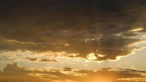 Dramatic sunset with sun beams thru clouds Video stock 110774139