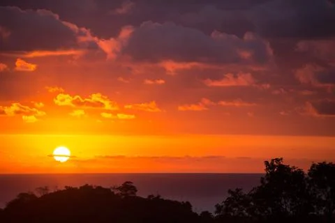 Dramatic sunset sun in clouds on the Pacific Stock Photos