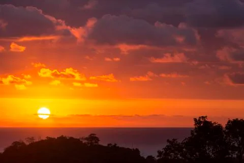 Dramatic sunset sun in clouds on the Pacific Stock Photos