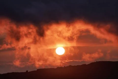 Dramatic sunset sun in clouds Stock Photos