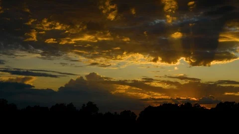 Dramatic sunset with sun rays coming thru clouds, colorful sky background Video stock 110774060