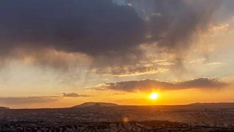 Dramatic sunset with sun rays over Cappadocia valley landscape Turkey Stock Photos