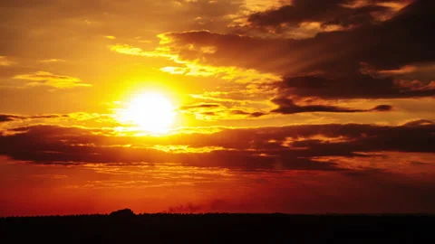 Dramatic Sunset with Sun Rays in the Sky Through Orange Layered Clouds Timelapse Stock Footage 209368323