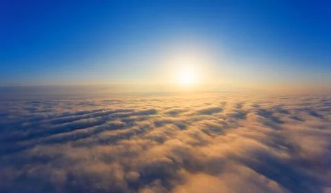 Dramatic sunset, the sun's rays shine through the clouds. Stock Photos