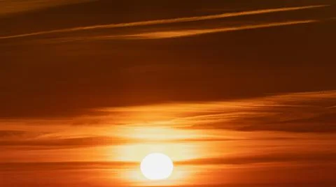 Dramatic sunset, the sun's rays shine through the clouds. Stock Photos