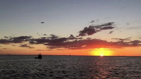 Dramatic Sunset Tampa Bay, Boat, Airplane Flying By Stock Footage 72599441