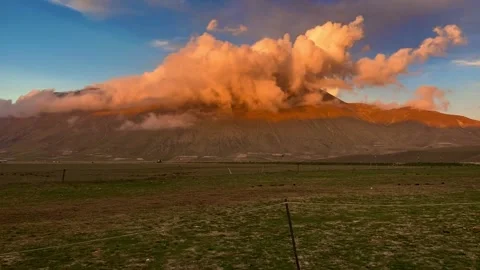 Dramatic sunset timelapse with clouds rolling over mountain Stock Footage 234429460