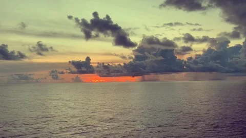 Dramatic sunset with vibrant colors over a calm ocean reflecting the light .. Stock Footage 338282198