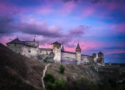 Dramatic sunset view on the castle in Kamianets-Podilskyi in spring. Stock Photos