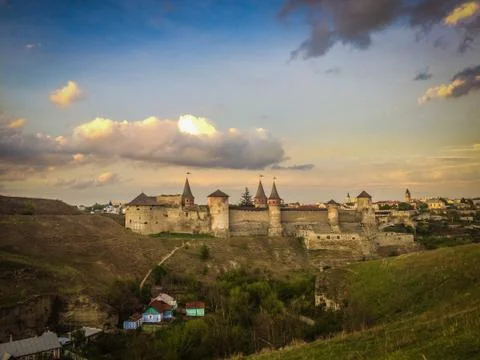 Dramatic sunset view on the castle in Kamianets-Podilskyi in spring. Stock Photos