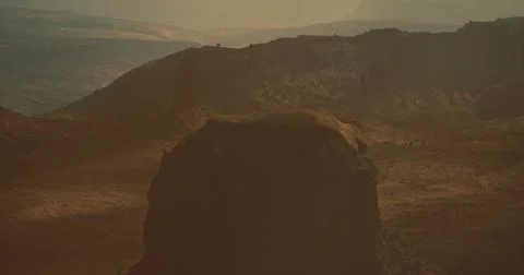 Dramatic sunset view over mountain landscape with rocky formations and shadow 스톡 일러스트
