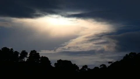 Dramatic sunset winter behind clouds, over the mountains. 4k P1120635 Stock Photos