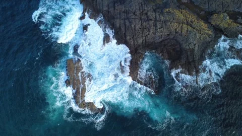 Dramatic Surf Patterns on Jagged Rocks Stock Footage 331628072