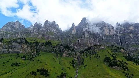 Dramatic Swiss Limestone Peaks Above Green Alpine Slopes Stock Photos