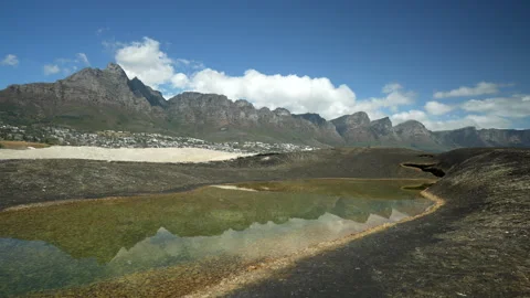Dramatic Table Mountain Timelapse with reflection in rock pool at the beach Stock Footage 345621234