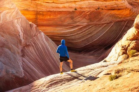 Dramatic Textures Surrounding Lone Desert Hiker at The Wave Stock Photos