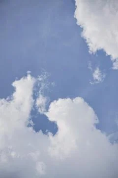 Dramatic thick cloud formations over mountain skies with sunlight piercing Foto stock