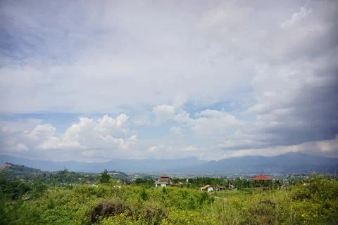 Dramatic thick cloud formations over mountain skies with sunlight 写真素材