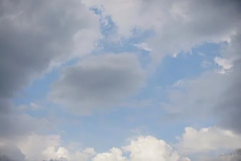 Dramatic thick cloud formations over mountain skies with sunlight piercing Foto stock