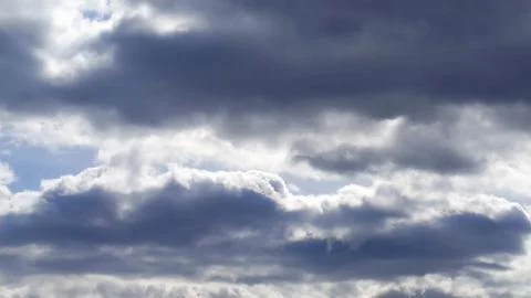 Dramatic thunder clouds against the blue sky. Cloudscape. Stock Photos