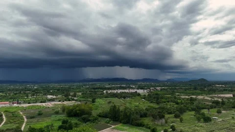 Dramatic thunderclouds approaching green valley during tropical monsoon Stock Footage 314358202