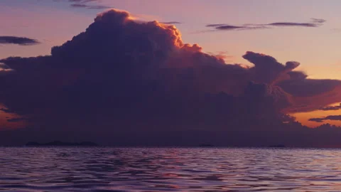 Dramatic Thunderstorm Cloud Rising Above Calm Ocean At Sunset In Slow Motion, Po Stock Footage 337152829
