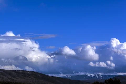 Dramatic thunderstorm clouds background at blue sky Stock Photos