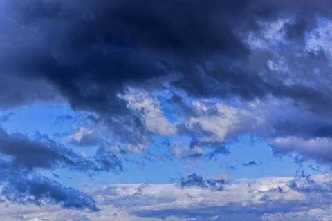Dramatic thunderstorm clouds background at blue sky Stock Photos