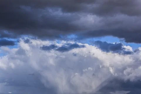 Dramatic thunderstorm clouds background at blue sky Stock Photos