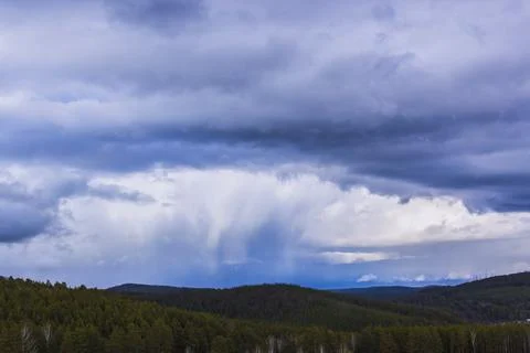 Dramatic thunderstorm clouds background at blue sky Stock Photos