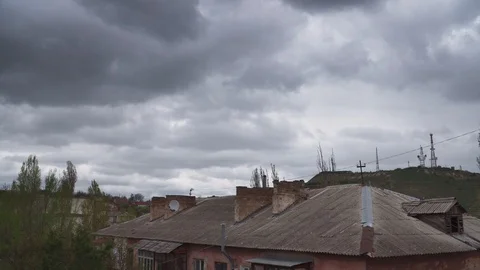 Dramatic thunderstorm clouds in the sky above the roof of the old big house Stock Footage 106729234