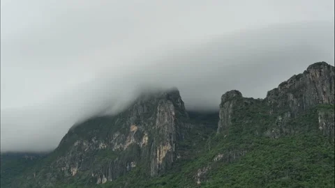 Dramatic Time lapse Cloud and fog cover limestone mountain in the rainy season Stock Footage 141502995