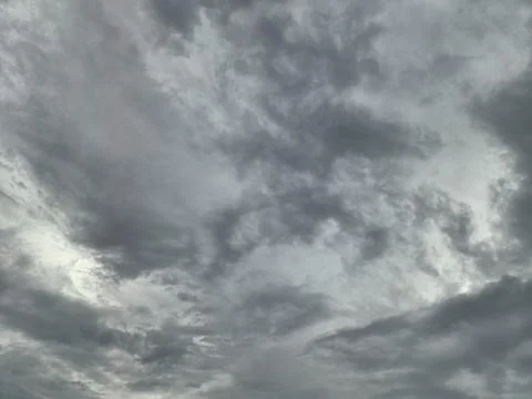 A dramatic time-lapse of dark storm clouds rolling across a windy summer sky 스톡 사진