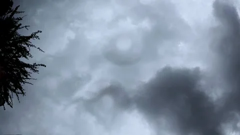 Dramatic time-lapse of dark, swirling storm clouds rolling across the sky as Видео 347248735