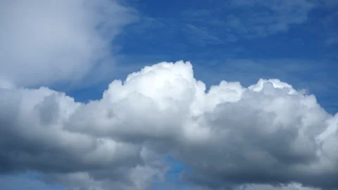 Dramatic time-lapse of Fluffy white clouds drift across a bright blue sky 스톡 동영상 279208668