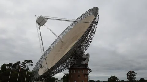 Dramatic time-lapse footage of a giant radio telescope antenna moving again.. Stock Footage 333815203