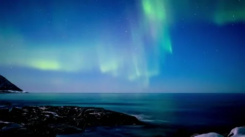 Dramatic Time-Lapse of Polar Lights Painting the Night Sky Over Lofoten Islands. 動画素材 334658965