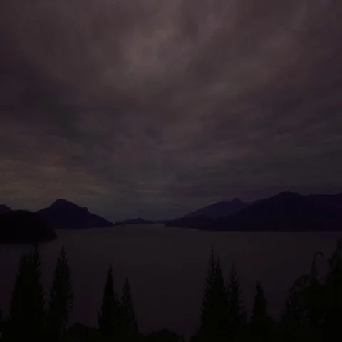 Dramatic timelapse of brightening clouds sweeping over Howe Sound at sunrise  Stock Footage 69723451