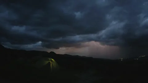 Dramatic timelapse of couple camping in tent atop mountain as thunderstorm .. Stock Footage 311127283