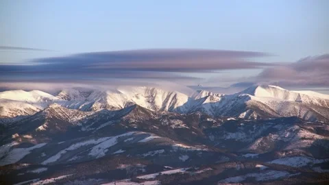 Dramatic Timelapse Detail of Distant Mountain Peaks with Snow and Smooth Cloud Stock-Footage 327521579