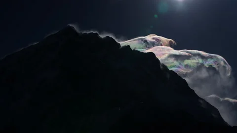Dramatic timelapse. Iridescent cloudscape chaos on gloomy summit. Air radiance Stock Footage 167324189
