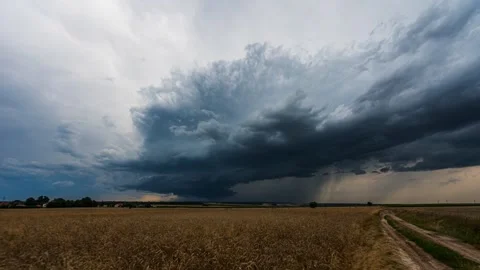 Dramatic timelapse showing the passage of a supercell thunderstorm over farmland Stock Footage 301523577