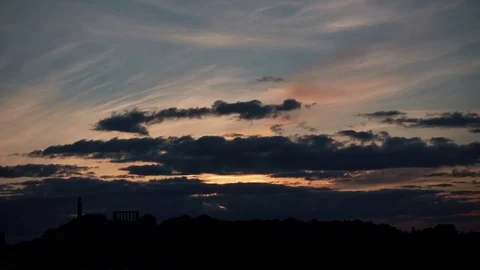 Dramatic timelapse of the sky above Edinburgh with Calton Hill in silhouette Stock Footage 78767680