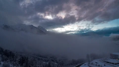 Dramatic Timelapse of Snowy Mountains Under Dark Cloudy Sky 4K UHD Video stock 329199449
