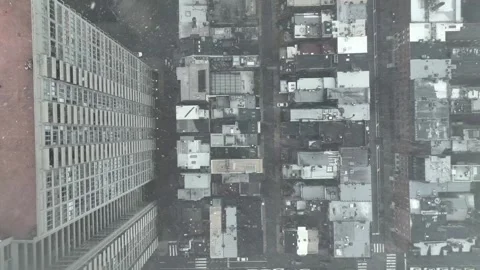 Dramatic top-down aerial view of dense American downtown during snowfall Stock Footage 330912941
