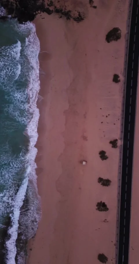 Dramatic top-down aerial view of a deserted pink sand beach with turquoise Stock Footage 344841785