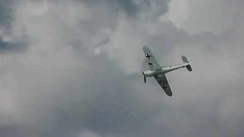 Dramatic tracking shot as Messerschmitt Bf-109 comes into focus and passes Stock Footage